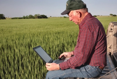 Farmer using rural broadband internet Farmer using rural broadband internet